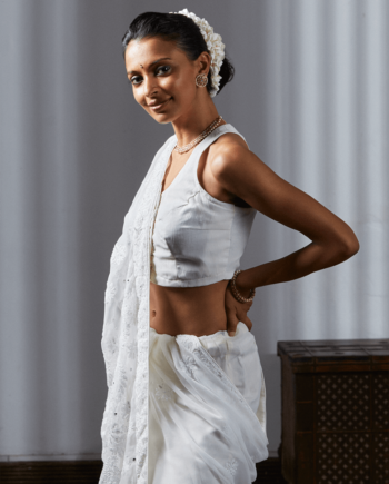 A woman wearing a Chikankari Oyster Silk Cotton Saree