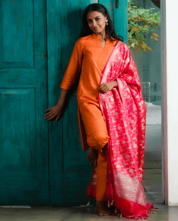 A woman wearing a orange kurtha and Benaras Silk Dupatta shawl